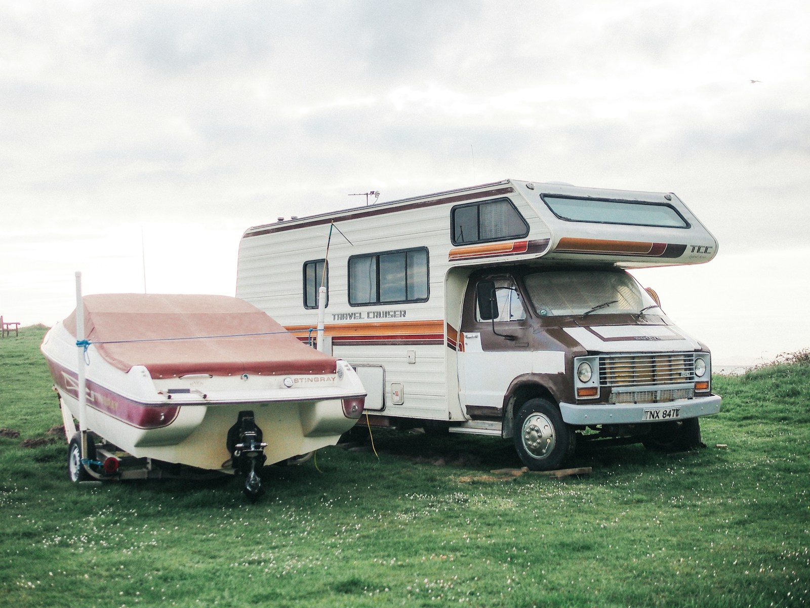 a motor home is parked next to a trailer, RV& boat